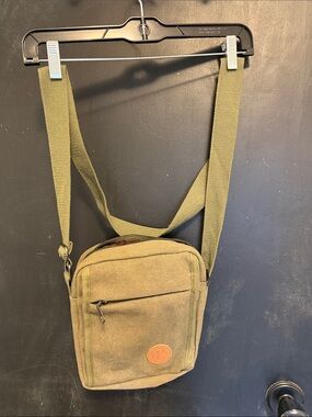 Unisex crossbody Nupouch crossbody bag. Olive colored with tan accent patch.